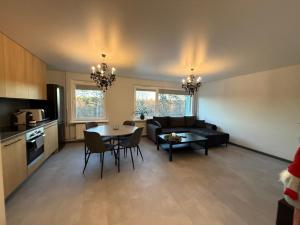 a living room with a couch and a table at Jumara Apartment in Valmiera