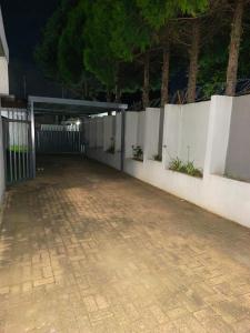 a parking lot with a gate and a fence at 37 on Bell self catering accommodation in Harrismith