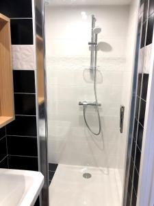 a shower with a glass door in a bathroom at Le Passiflore in Beuvron-en-Auge +37 photos