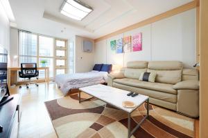 a living room with a couch and a table at Gangnam Opal in Seoul