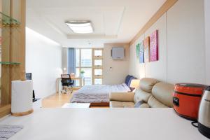 a living room with a couch and a bed at Gangnam Opal in Seoul
