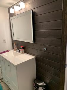 a bathroom with a white sink and a mirror at Luxurious Lakefront Cottage, Sleeps 12 in Bewdley +88 photos