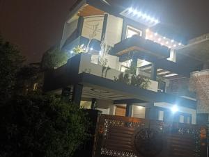 a tall building with a balcony at night at Emporia Hotel & Suites in Lahore