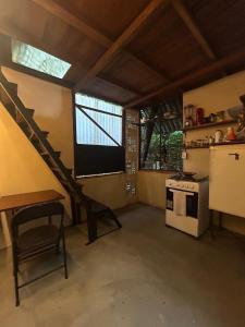 a living room with a staircase and a kitchen at Estudio Embira - Lago Verde in Santarém +12 photos