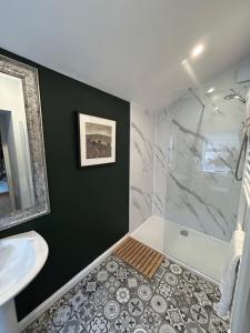 a bathroom with a shower and a sink at Fox Cottage in Moffat +6 photos