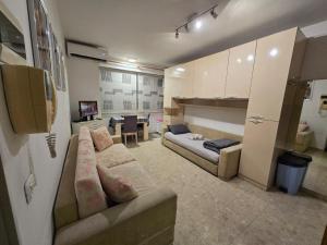 a living room with a couch and a table at City Center Piazza Studio in Tirana