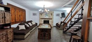 a living room with a couch and a fireplace at Casa Rural Ruiz Hernando in Villanueva del Arzobispo