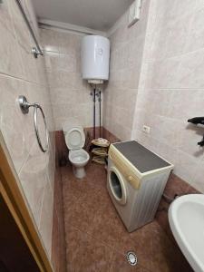 a bathroom with a toilet and a sink at City Center Piazza Studio in Tirana