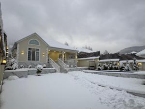 a house with snow on the ground in front of it at Vendam sweet Home in Vǝndam
