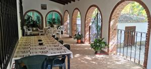 a patio with arches and tables and chairs in a building at Casa Rural Ruiz Hernando in Villanueva del Arzobispo
