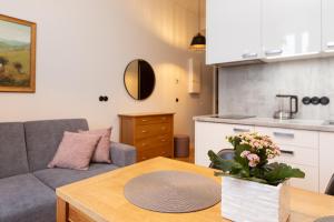 a living room with a couch and a table at Cozy Duo Loft Studio in Tartu