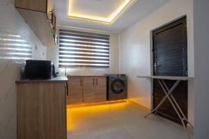a kitchen with a clock in the corner of a room at Love Square Platinum in Ilora
