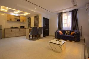 a living room with a couch and a table at Love Square Platinum in Ilora