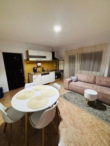 a living room with a table and a couch at Apartament Cozy in Gherla