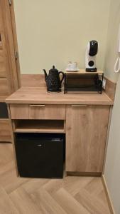 a kitchen with a wooden counter top with a black appliance at Delux Apartament z jacuzzi in Pszczyna