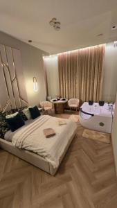 a bedroom with a large bed and a sink at Delux Apartament z jacuzzi in Pszczyna