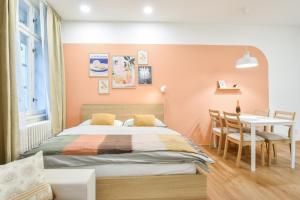 a bedroom with a bed and a dining table at Olomouc Central Apartment in Olomouc