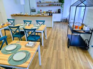 a dining room with wooden tables and blue chairs at B&B Magnolie in Palermo