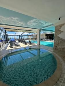 a swimming pool on the top of a building at Hotel SPICH - Pearl Beach Resort in Čanj