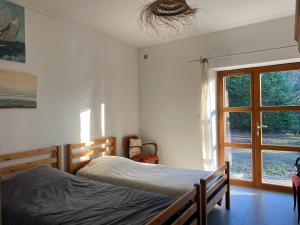 a bedroom with a bed and a window at Maison familiale in Vars