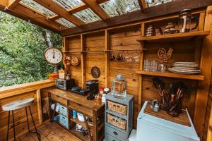 a kitchen in a cabin with a counter and a clock at Creek-side Retreat - Glamping in The Dalles