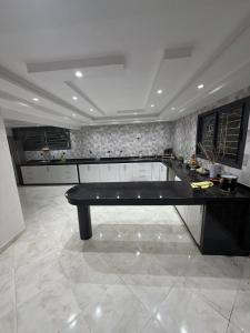 a large kitchen with a black table in a room at Saad's villa in Mohammedia