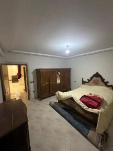 a bedroom with a bed with a red bag on it at Saad's villa in Mohammedia