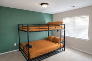 2 stapelbedden in een kamer met een groene muur bij Crew Stay Sleeps 16 Work, Cook, Play & Relax in Navo