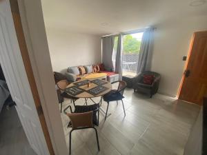 a living room with a table and chairs and a couch at casa reñaca sector jardín del mar in Viña del Mar
