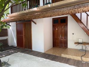 a building with two wooden doors and a balcony at Travel Lodge by Rashuthere in Rasdu