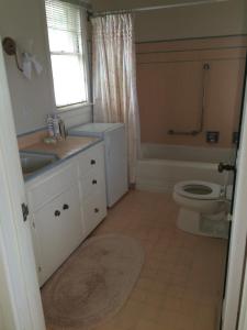 a bathroom with a sink and a toilet and a window at Elegant suite-30 day minimum in Carmel +7 photos