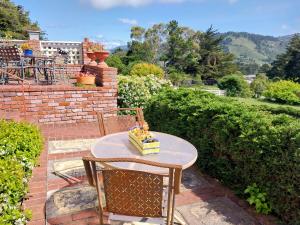 a table and chairs with a cake on a patio at Elegant suite-30 day minimum in Carmel