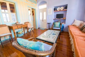 a living room with a couch and a table at Symi Traditional Appartment in Symi