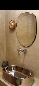 a bathroom sink with a large mirror above it at Paradox in Thessaloniki +104 photos