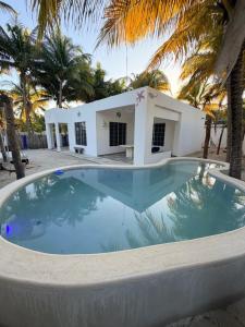 a swimming pool in front of a villa at Casa De Los Peces in San Crisanto