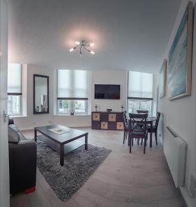 a living room with a table and a dining room at Bluetree Apartments Guild Street City Center in Aberdeen
