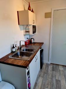a small kitchen with a sink and a counter top at Sun Republik Studio in Whitianga +18 photos