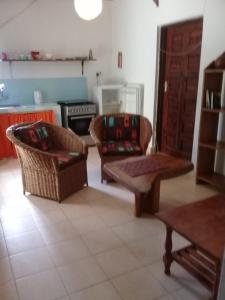 a living room with two chairs and a couch at Diani Tembo One Bedroom in Mombasa