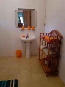 a bathroom with a sink and a mirror at Diani Tembo One Bedroom in Mombasa