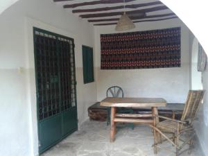 a table and chair in a room with a wall with wine bottles at Diani Tembo One Bedroom in Mombasa