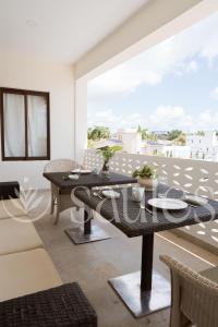 a dining room with a table and a balcony at Saules Sueño in Cancún