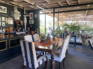 a dining room table with white chairs around it at Cajanegra in El Cerrillo
