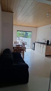 a large living room with a table and a kitchen at Aluguel diária in Florianópolis