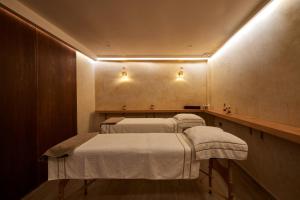 two beds in a room with lights on the wall at Zen Zone Boutique Riad & Spa in Marrakesh
