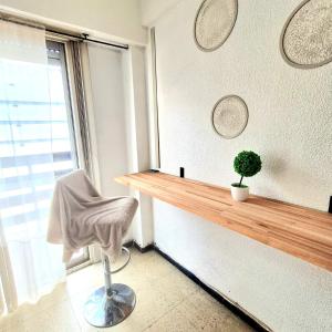 a room with a table and a chair and a window at Del Paseo al Mar in Mar del Plata