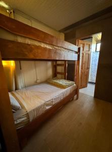 een slaapkamer met een stapelbed in een kamer bij Cabina Entre Playas in Huacas