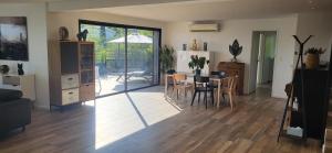 a living room with a table and a dining room at Architect-designed villa, overlooking Agay Bay in Saint-Raphaël