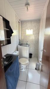 a small bathroom with a toilet and a sink at Bruna in Florianópolis