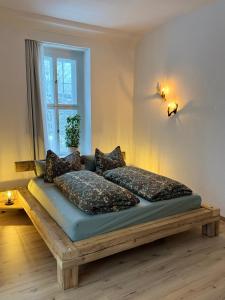 a bed sitting in a room with a window at Waldquartier Erzgebirge in Thermalbad Wiesenbad