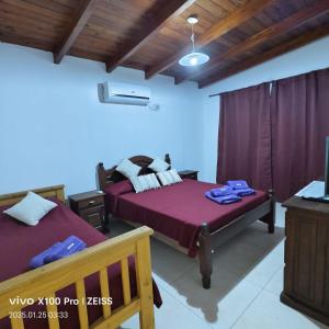 a bedroom with two beds and a tv in it at DUPLEX Stadium in Tanti +15 photos